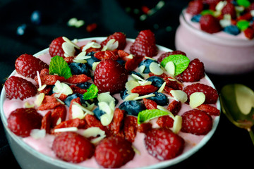 Smoothie Bowl with Raspberries, Blueberries,Goji Berries and Mint.Fresh Fruit Heath Breakfast
