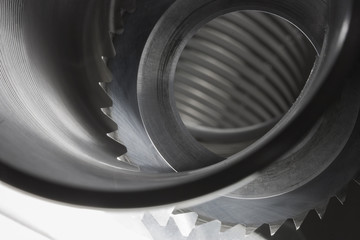 Carbide saw in a steel wire coil lit from beneath. Both used in making parts for automotive...