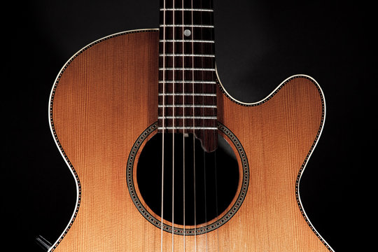 Roundback acoustic guitar with rosette purfling and extended fingerboard in close up.