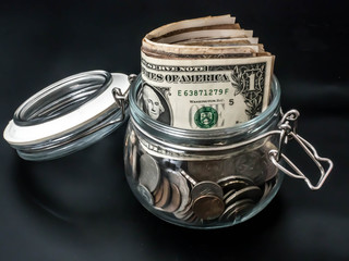 Saving money concept,  Dollar banknotes and coins in Glass Jar