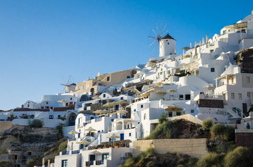 Oia Village, Santorini Cyclades islands, Greece. Beautiful view of the town with white buildings and some windmills.