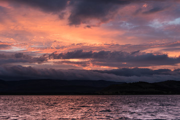 Dramatic cloudy sunset on a lake