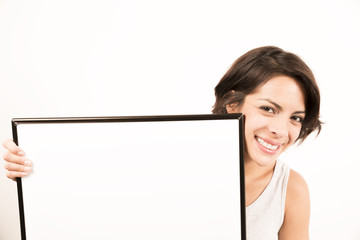 Beautiful young woman holding a blank sheet of paper