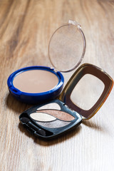 Fototapeta na wymiar Women's cosmetics - powder and shadows in package