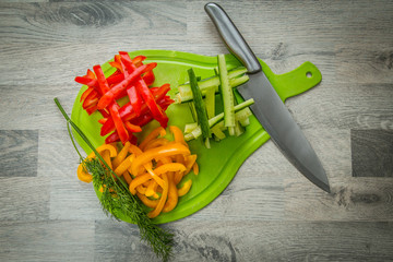 Vegetables and greens on cutting board