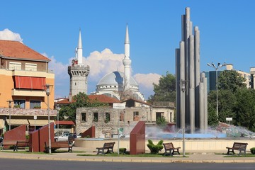 Fototapeta na wymiar Shkoder, Albania: View of the central square Sheshi Demokracia with fountain, English tower, Ebu Bekr Mosque and Franciscan church. South-east Europe. 