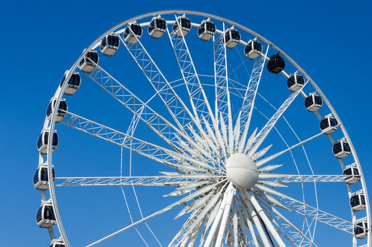 Giant ferris wheel on clear blue sky background in Gdansk, Poland