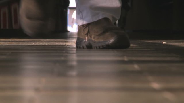 Anonymus workers walking in factory entry corridor
