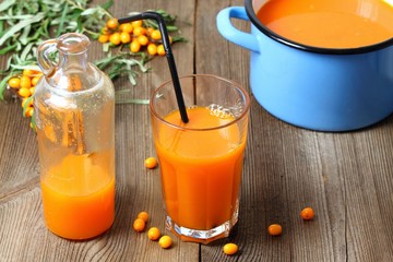 Homemade sea buckthorn smoothie, Hippophae rhamnoides, wood table