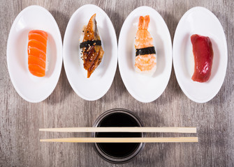 four kinds of Nigirisushi on saucers