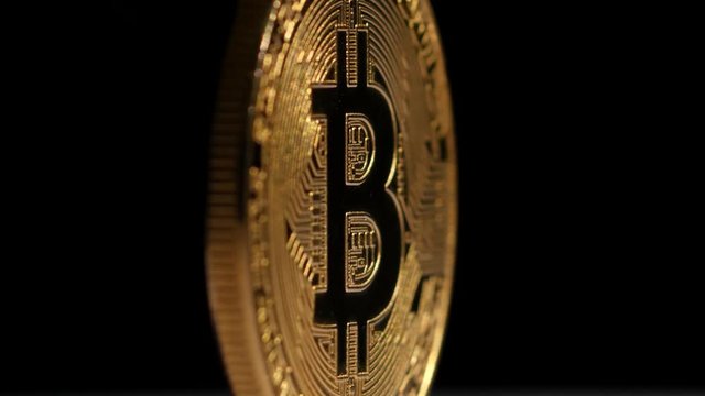 Crypto currency Gold Bitcoin - BTC - Bit Coin. Rotating on black.