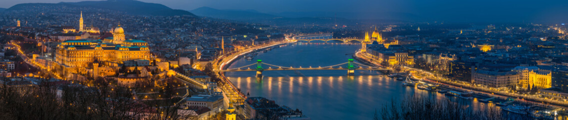 Fototapeta premium Budapest, Hungary - Panoramic skyline view of Budapest with Historic Royal Palace, Matthias Church, Szechenyi Chain Bridge, St. Stephen's Basilica and Parliament of Hungary at blue hour