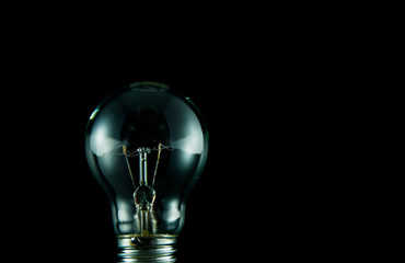 Old light bulb isolated on black.