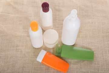 Cosmetics in bottles of plastic containers and tubes