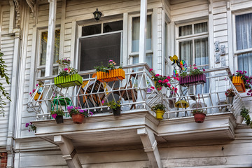 beautiful wooden white balcony with  flower pots exterior daylight view