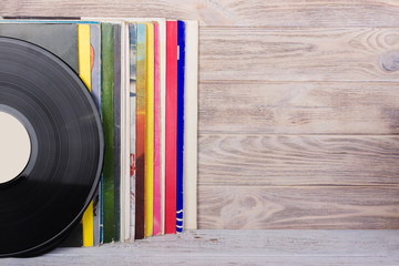 Vinyl records and headphones on table. Vintage vinyl disk