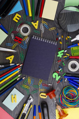 Back to school. Set of school objects for modern education: pens, scissors, pensils and other multicolored accessories on wooden desk