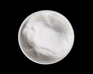 Pile rice flour in bowl isolated on black background