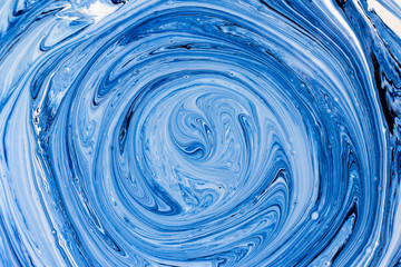 Abstract background. Paints. Fantastic patterns obtained by mixing blue paint white