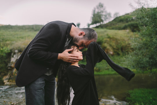 Man kissing little daughter