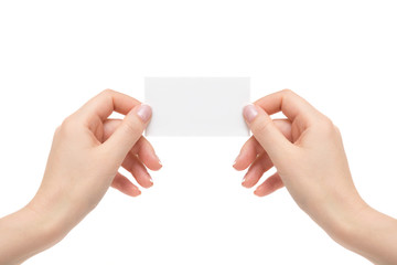Isolated female hands hold white card on a white background.