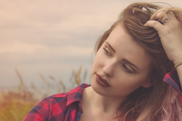 Fashion portrait of young hipster women with pretty red lips Summer concept, sandy beach, bright sky and sea. Tourism, travel, holidays. Washed effect