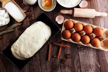 Bakery ingredients - flour, eggs, butter, sugar, yolk, almond nuts on blue table. Sweet pastry baking concept.