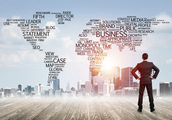 Motivation and inspiration concept with modern cityscape and businessman observing it