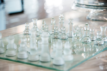 transparent glass chess board on the table