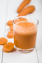 Carrot juice on a wooden table