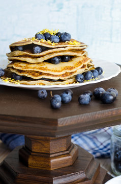 Pancakes with blueberry on white plate.