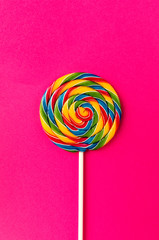 Tasty appetizing Party Accessory Sweet Swirl Candy Lollypop on Pink Background Top View