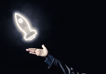 Man palm presenting Rocket web icon as technology concept