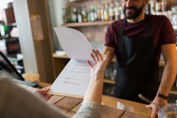 bartender and customer menu at bar