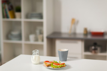 Fototapeta na wymiar sandwiches with coffee and cream at home kitchen