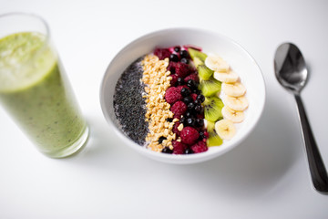 smoothie and bowl of yogurt with fruits and seeds