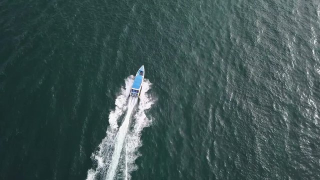 4K Aerial view of speedboat to the island