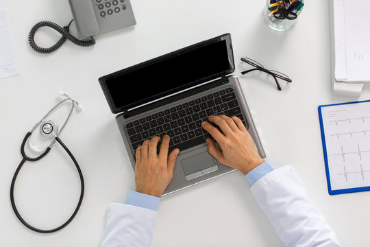 Doctor Hands Typing On Laptop At Clinic