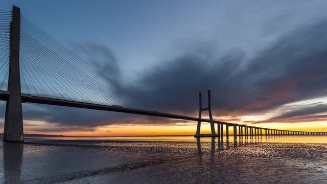 Timelapse of the beautiful sunrise over the Vasco da Gama Bridge. Lisbon, Portugal. April, 2017.