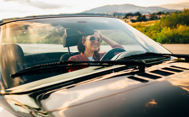 Woman drive cabriolet car: sunset time, mountain province road