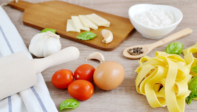 Preparation Italian Raw Homemade Pasta Tagliatelle Cooking Baking Kitchen Table Wooden Different Ingredients Eggs Olive Oil Tomato Flour Basil Pepper Garlic Top View