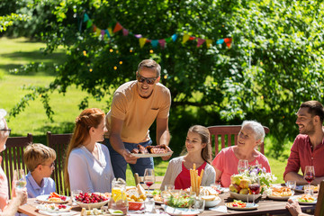 happy family having dinner or summer garden party