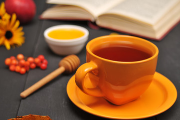 Autumn still life cup of tea, honey and book on the table