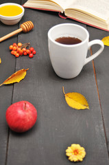 Autumn still life cup of tea, honey and book on the table