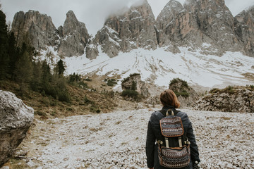 Woman traveler with backpack going to mountains