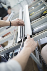 Manual worker assembling PVC doors and windows. Manufacturing jobs. Selective focus. Factory for aluminum and PVC windows and doors production.