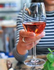 A glass of red wine in beautiful female hands
