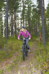 Naklejka premium Young girl riding a mtb