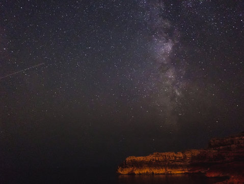 Milky way and shooting star over the cliff, long exposure image