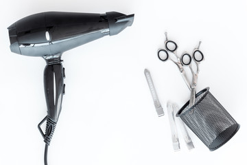 hairdresser work desk with tools for hair styling on white background top view space for text
